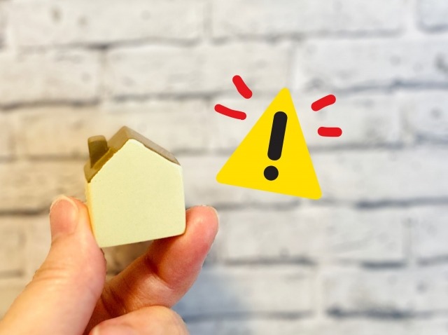 家の模型と注意喚起マーク
